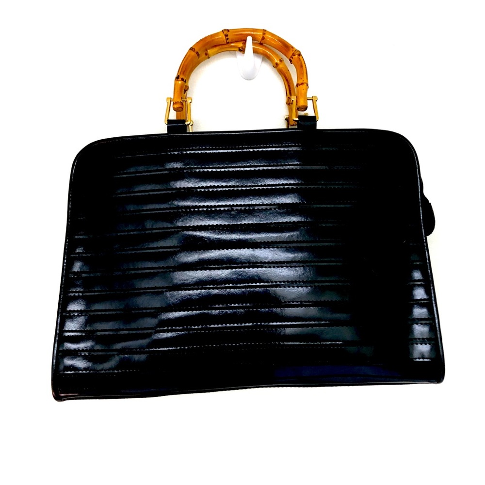Design by Pristine black purse with wooden handle.